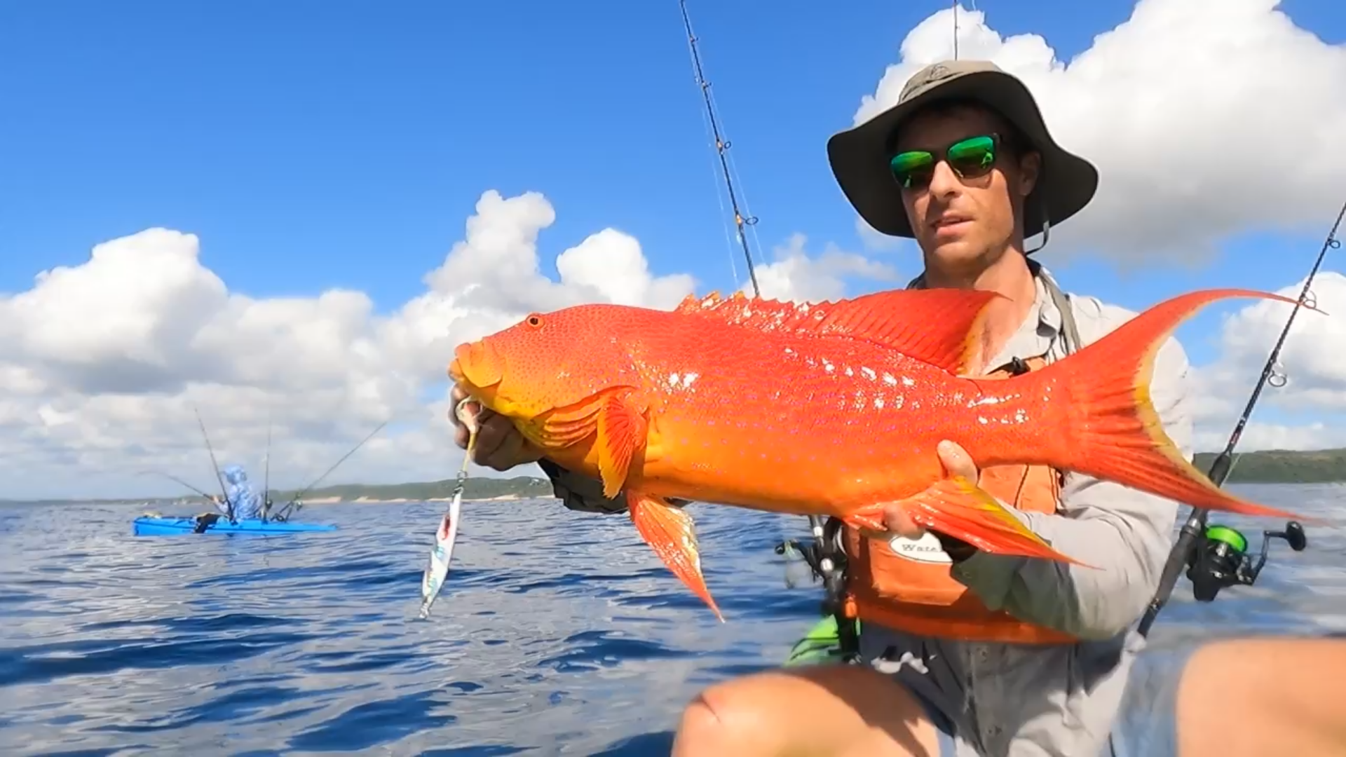 Angler holding a bright red fish caught jigging