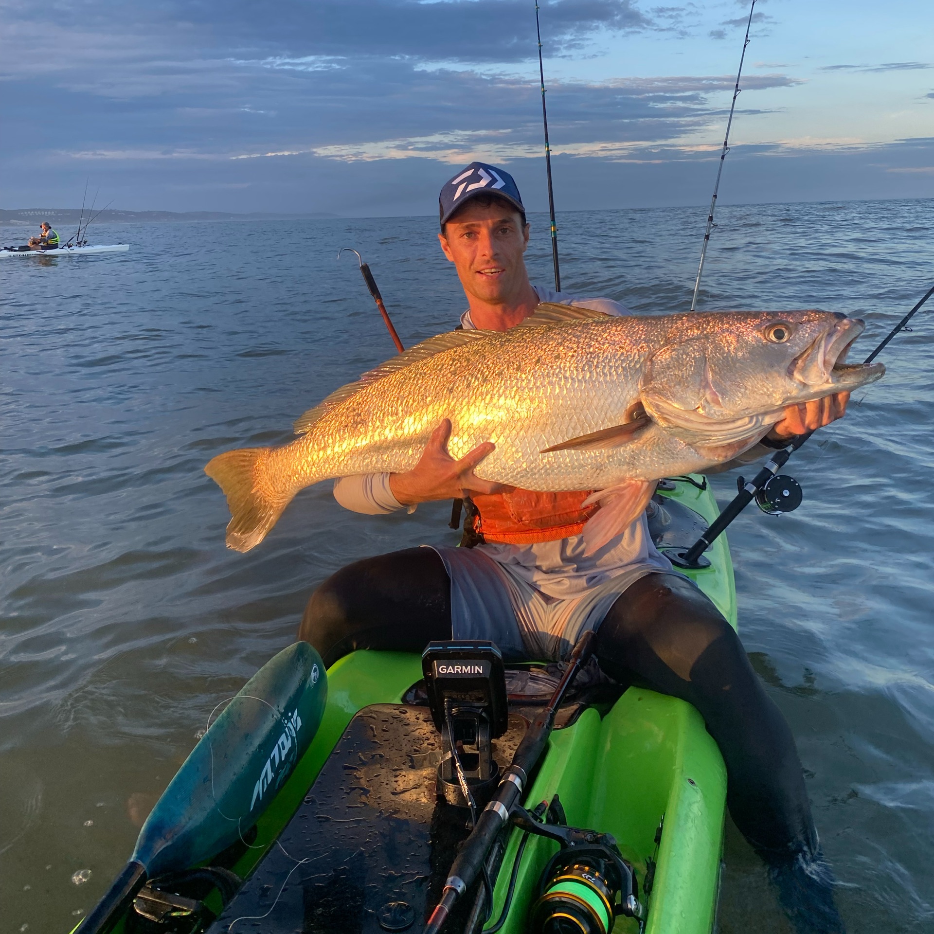 Sunset catch held up from the kayak