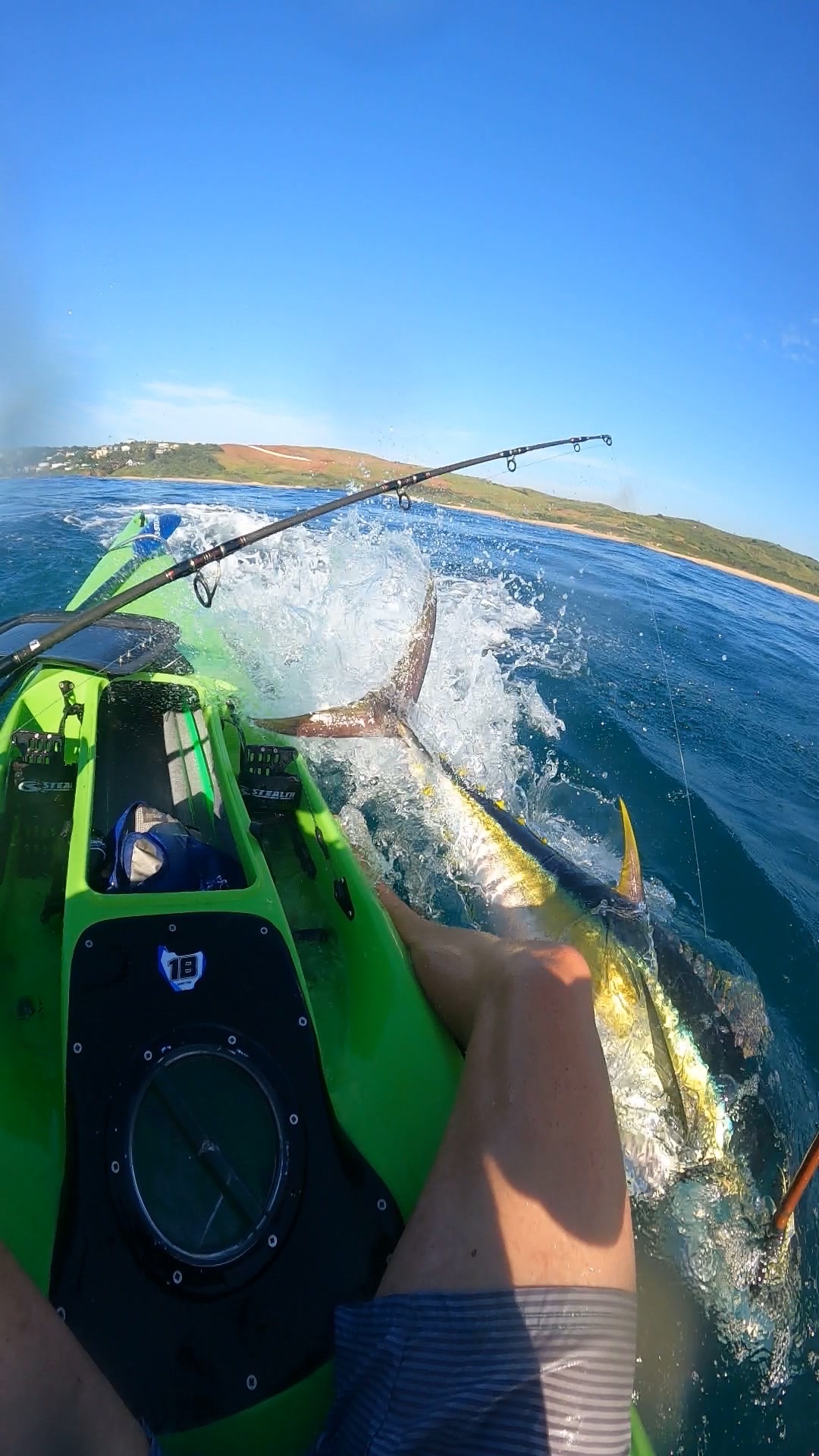 Kayak punching through a breaking wave